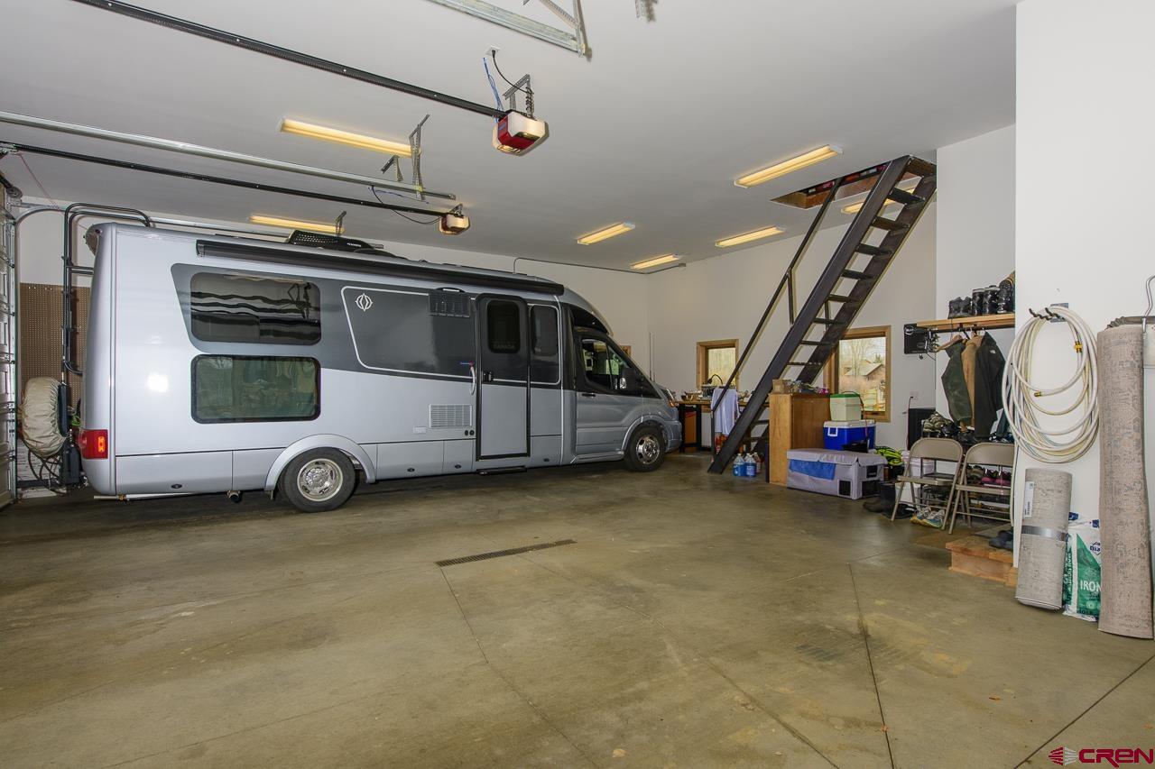 157 Spring Meadow Trail Gunnison, CO 81230 - Photo 26 of 43 Stairs lead to the oversized attic area for storage.