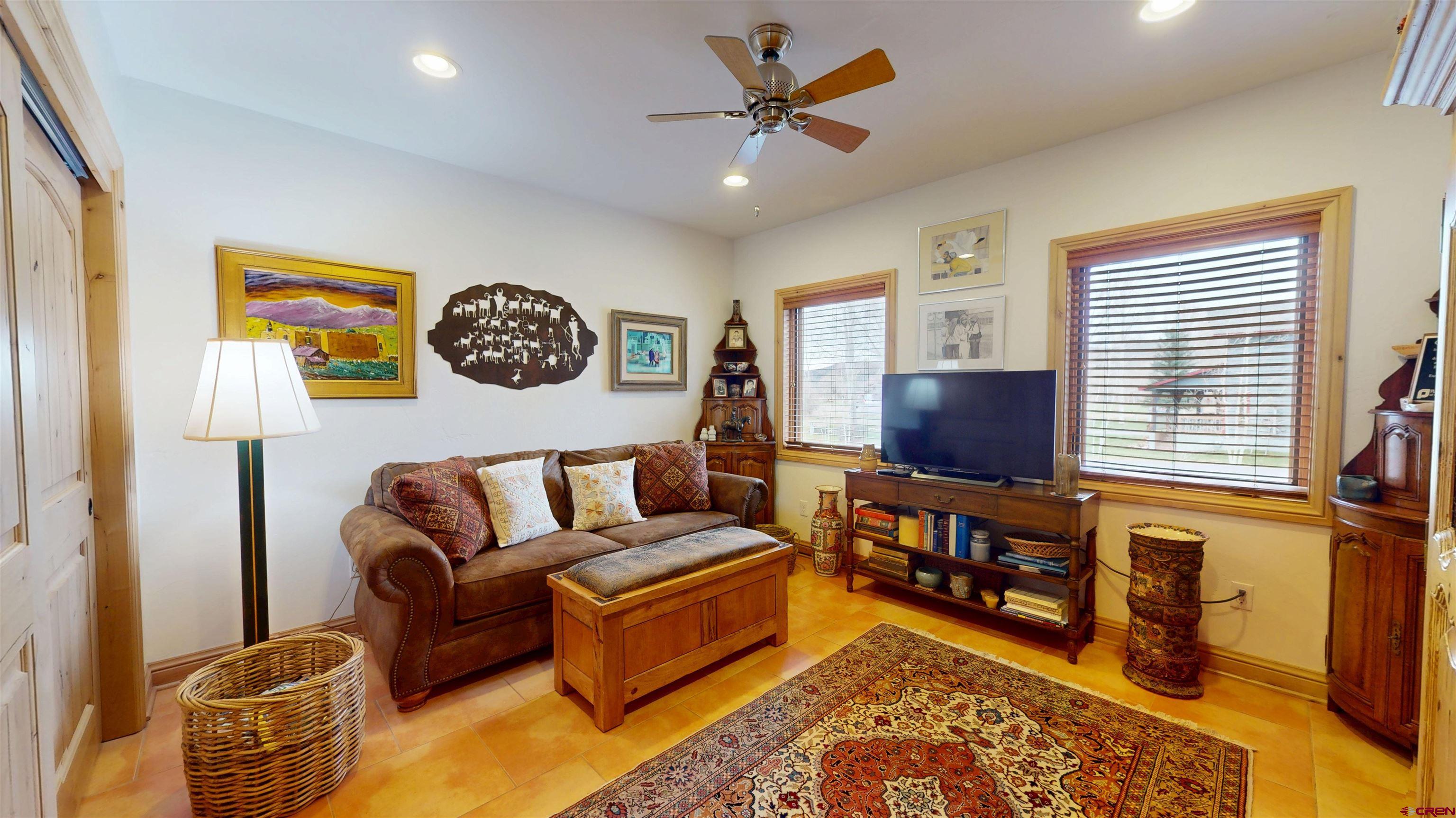 157 Spring Meadow Trail Gunnison, CO 81230 - Photo 28 of 43 a living room with furniture and a flat screen tv