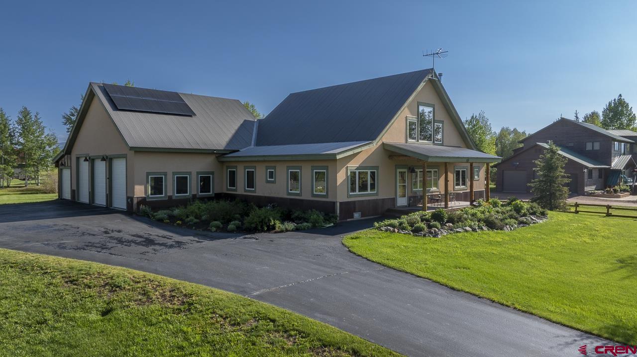 157 Spring Meadow Trail Gunnison, CO 81230 - Photo 3 of 43 a front view of a house with a yard