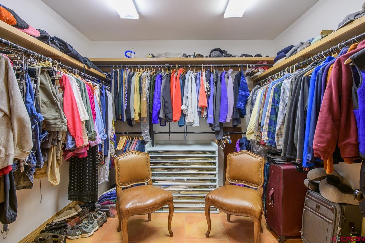 157 Spring Meadow Trail Gunnison, CO 81230 - Photo 35 of 43 a view of walk in closet with clothes and shoes