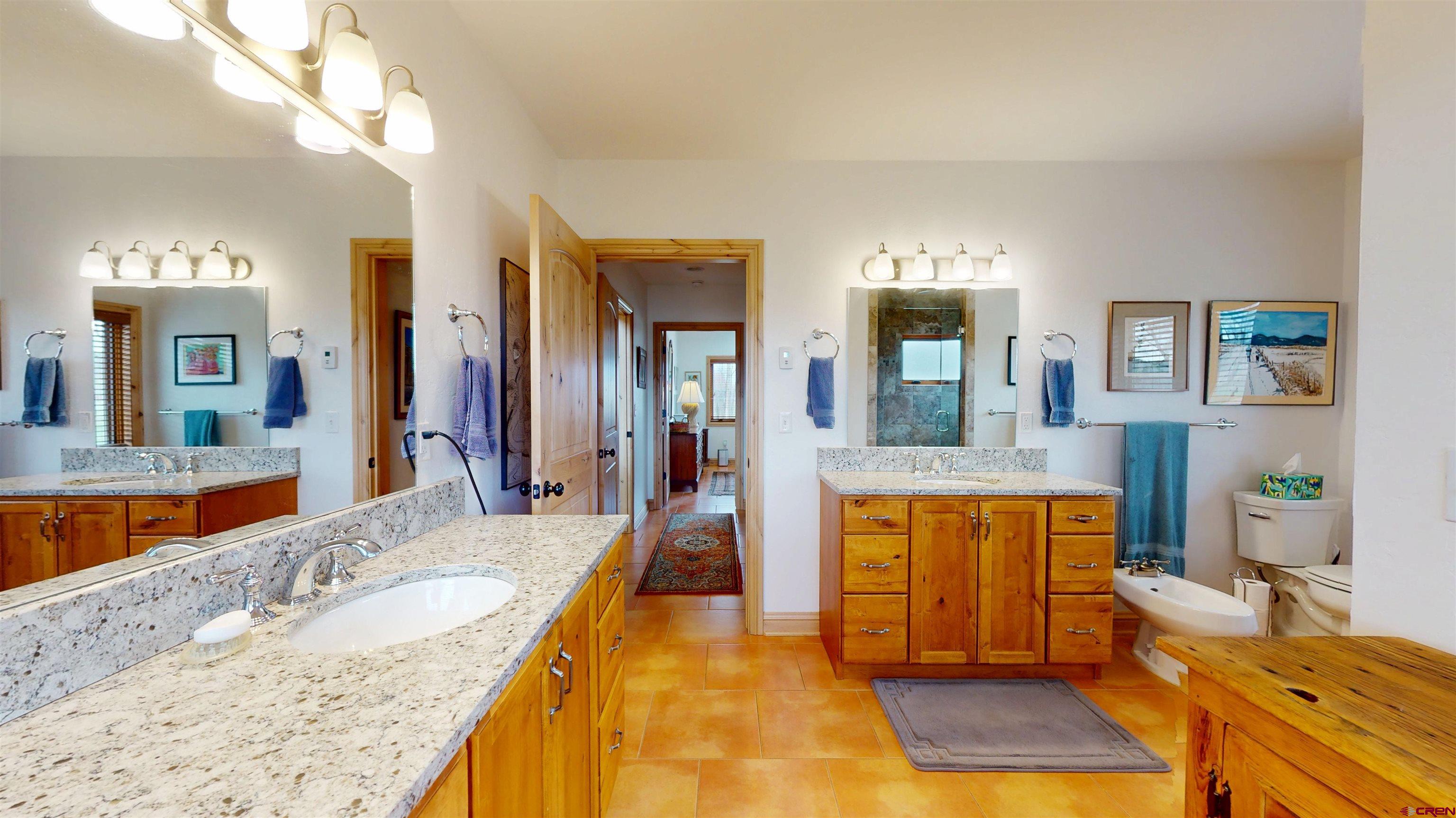 157 Spring Meadow Trail Gunnison, CO 81230 - Photo 36 of 43 a large spacious bathroom with a granite countertop double vanity sink a mirror and bathtub