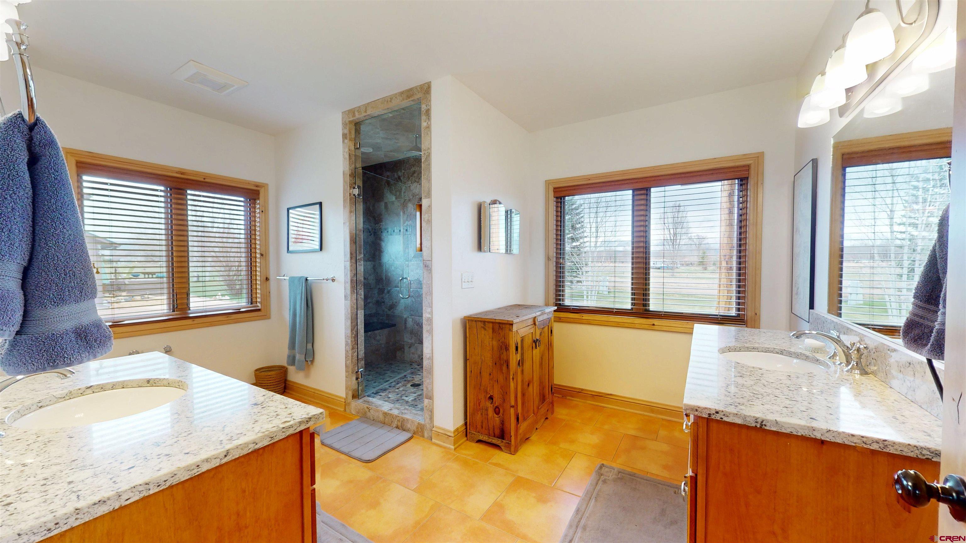 157 Spring Meadow Trail Gunnison, CO 81230 - Photo 37 of 43 a bathroom with a granite countertop sink and a bathtub