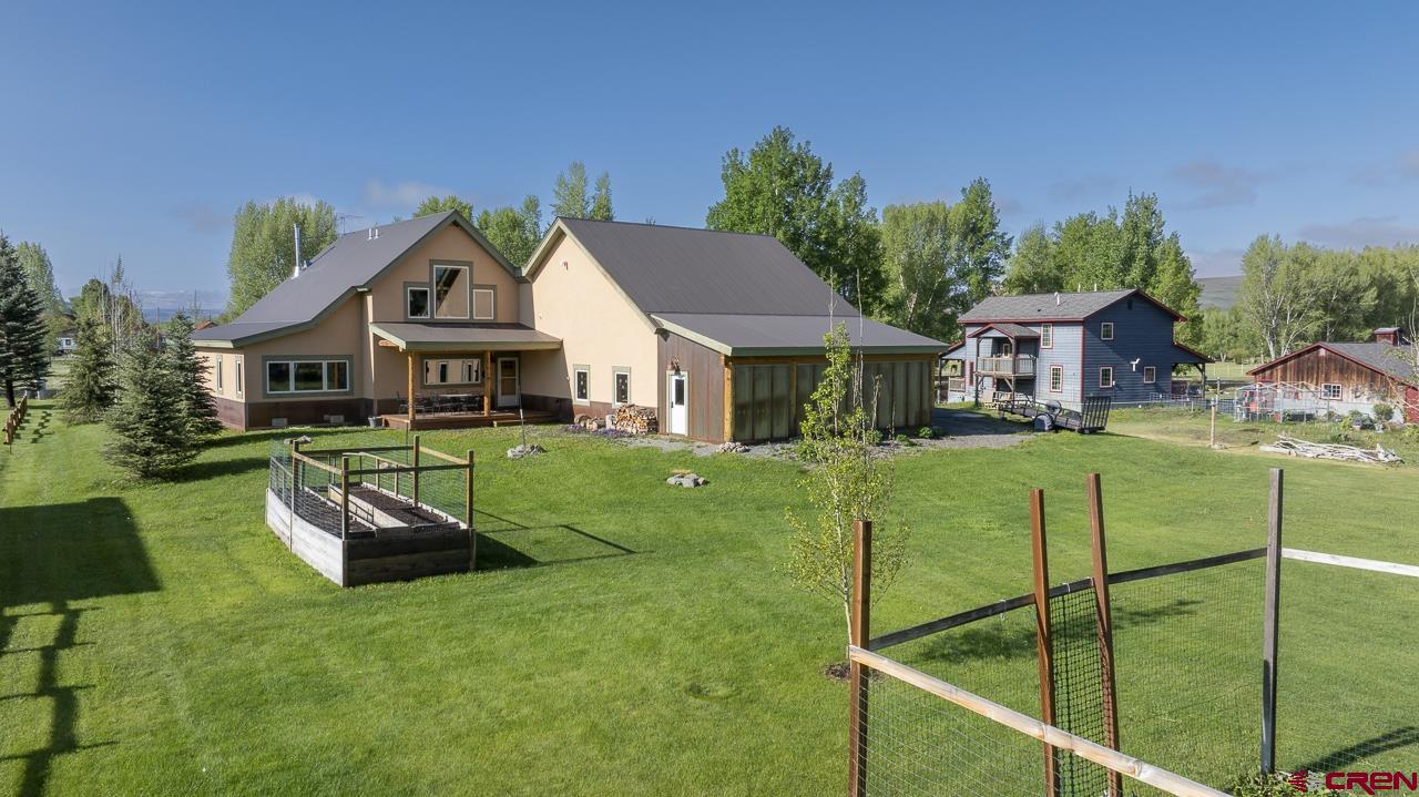 157 Spring Meadow Trail Gunnison, CO 81230 - Photo 4 of 43 a front view of a house with a yard table and chairs