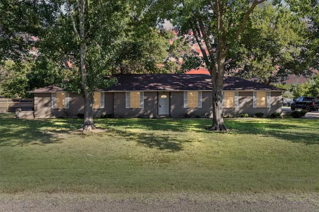 a view of a house with a yard and tree