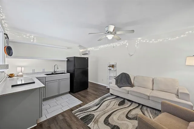 a living room with furniture and kitchen view