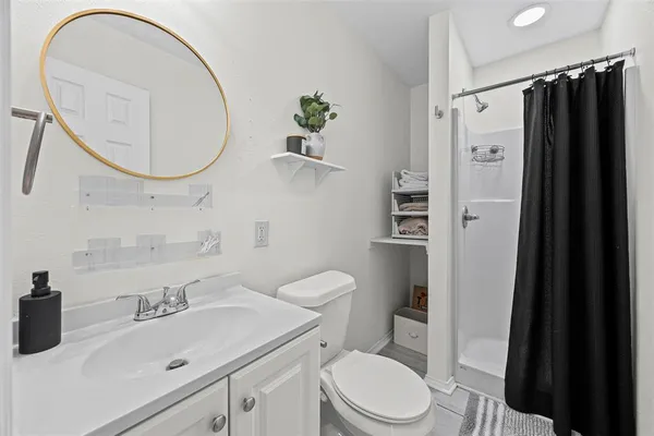 a bathroom with a sink a toilet and a mirror