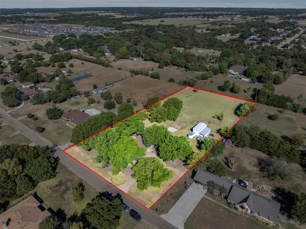an aerial view of a houses with a yard