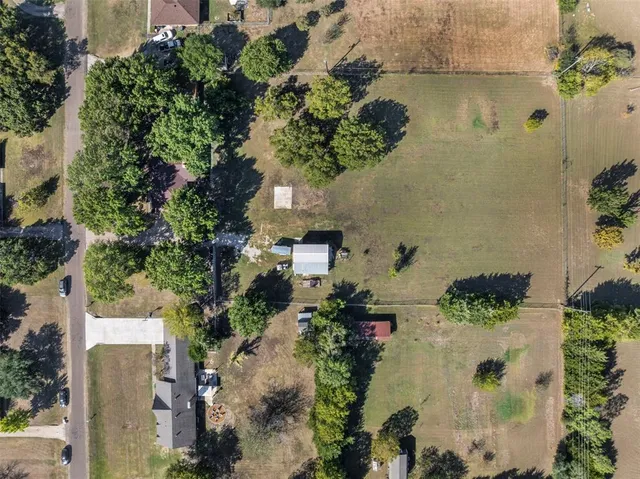 an aerial view of residential houses with outdoor space