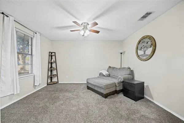 a living room with furniture a clock and a window