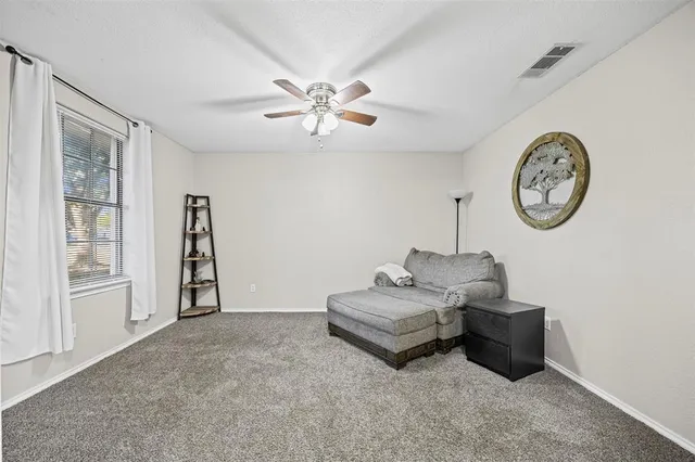 a living room with furniture a clock and a window