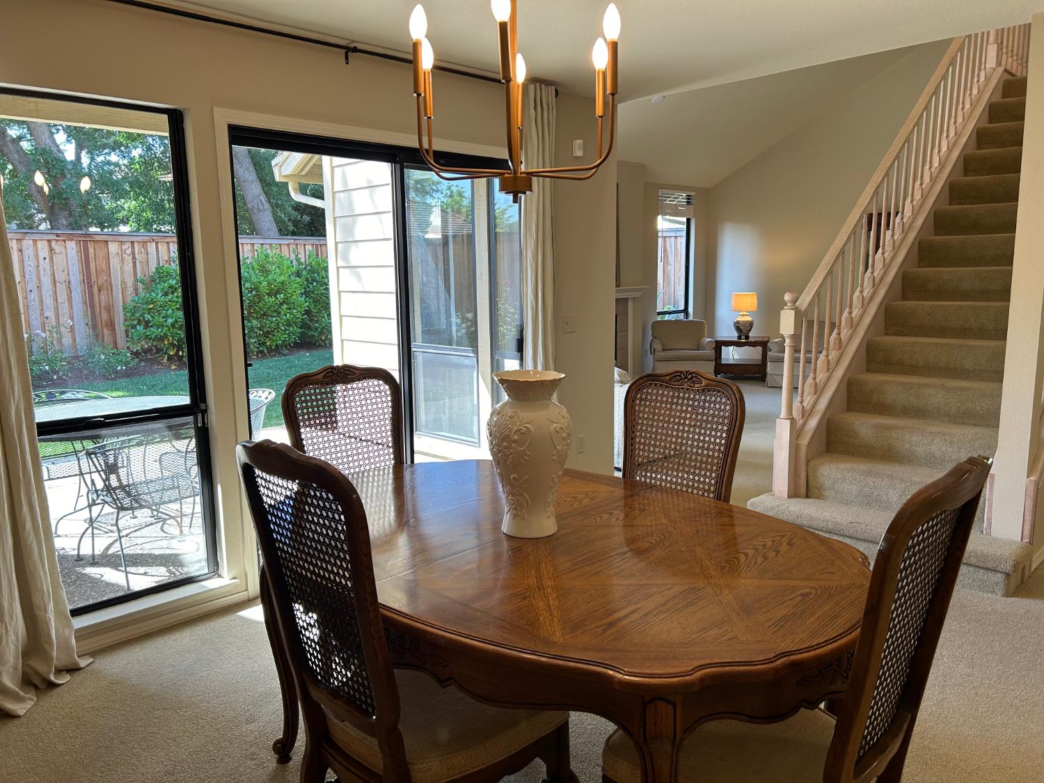 1067 Rio Cidade Way Sacramento, CA 95831 - Photo 14 of 33 a dining room with furniture a chandelier and wooden floor