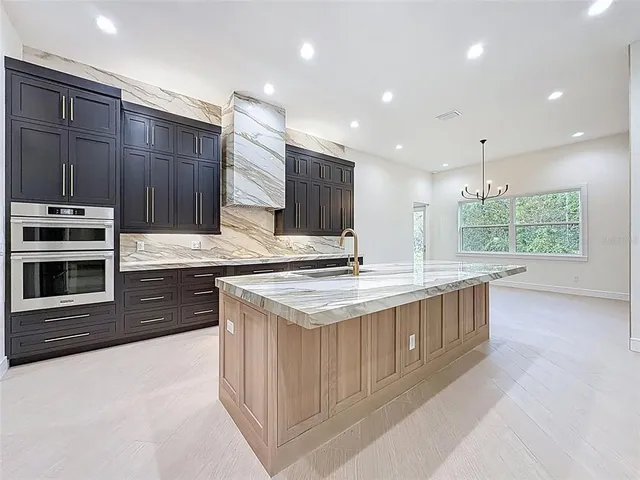 a view of a hallway to kitchen and living room