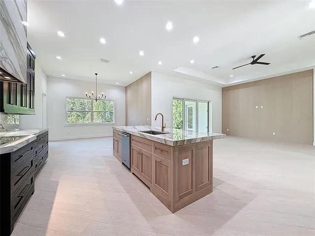 an empty room with a window and a ceiling fan