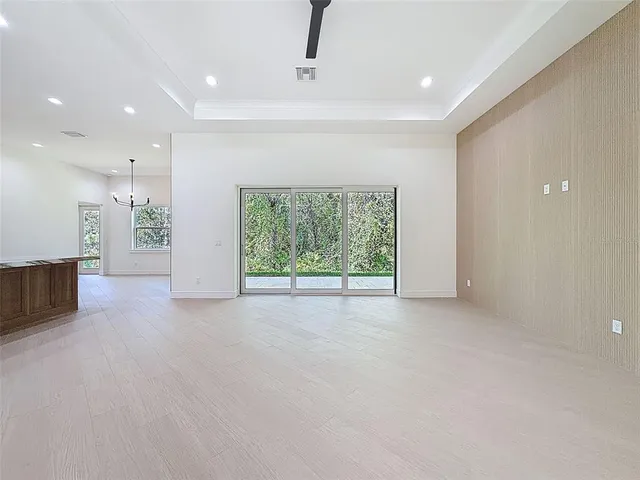 a bathroom with a granite countertop sink a toilet a mirror and a window