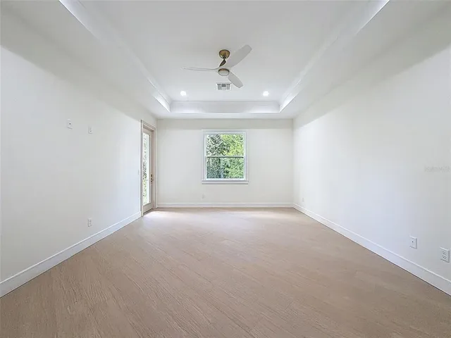 a view of a livingroom with a ceiling fan and window