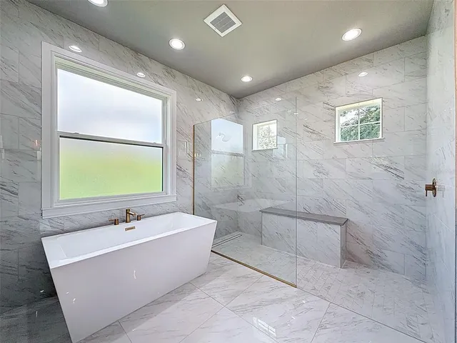 an aerial view of residential houses with outdoor space and trees