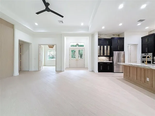 a bathroom with a granite countertop sink and a large mirror