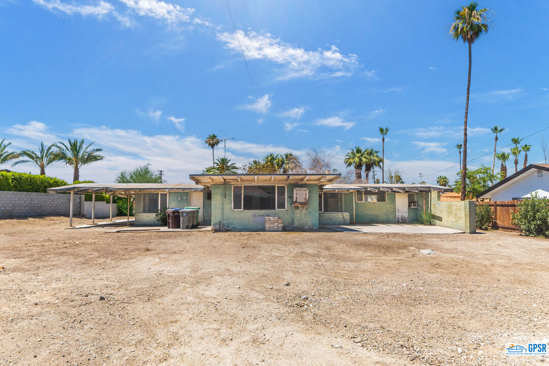 Undisclosed Address Palm Desert, CA 92260 - Photo 24 of 33 a front view of a house with a yard and garage