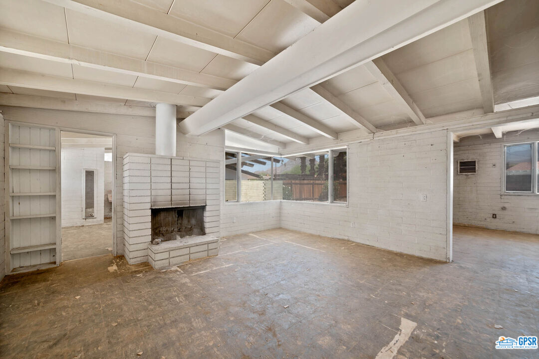 Undisclosed Address Palm Desert, CA 92260 - Photo 4 of 33 an empty room with fireplace