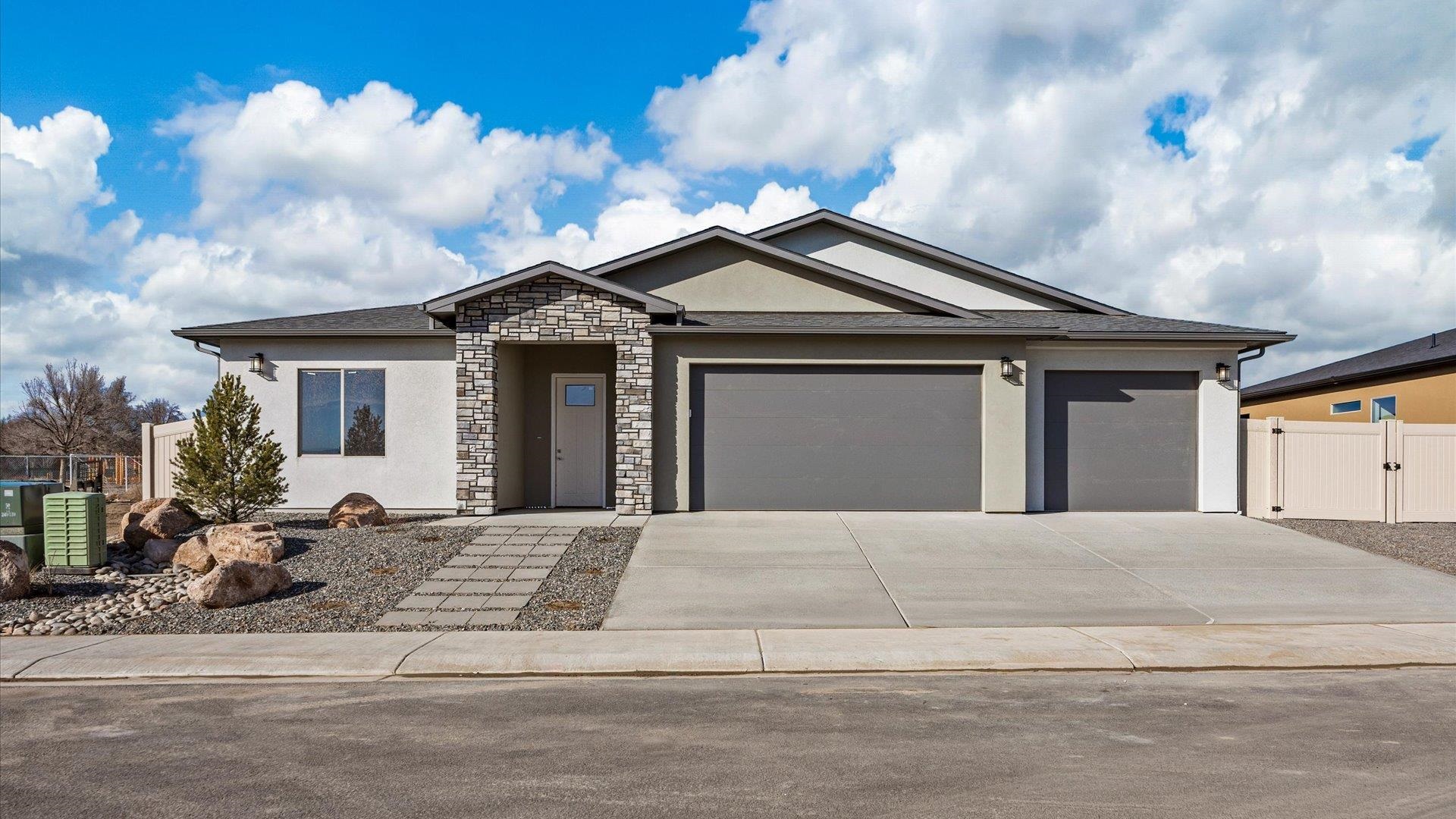 3066 Thunderhead Way Grand Junction, CO 81504 - Photo 1 of 30 a front view of a house with a garden