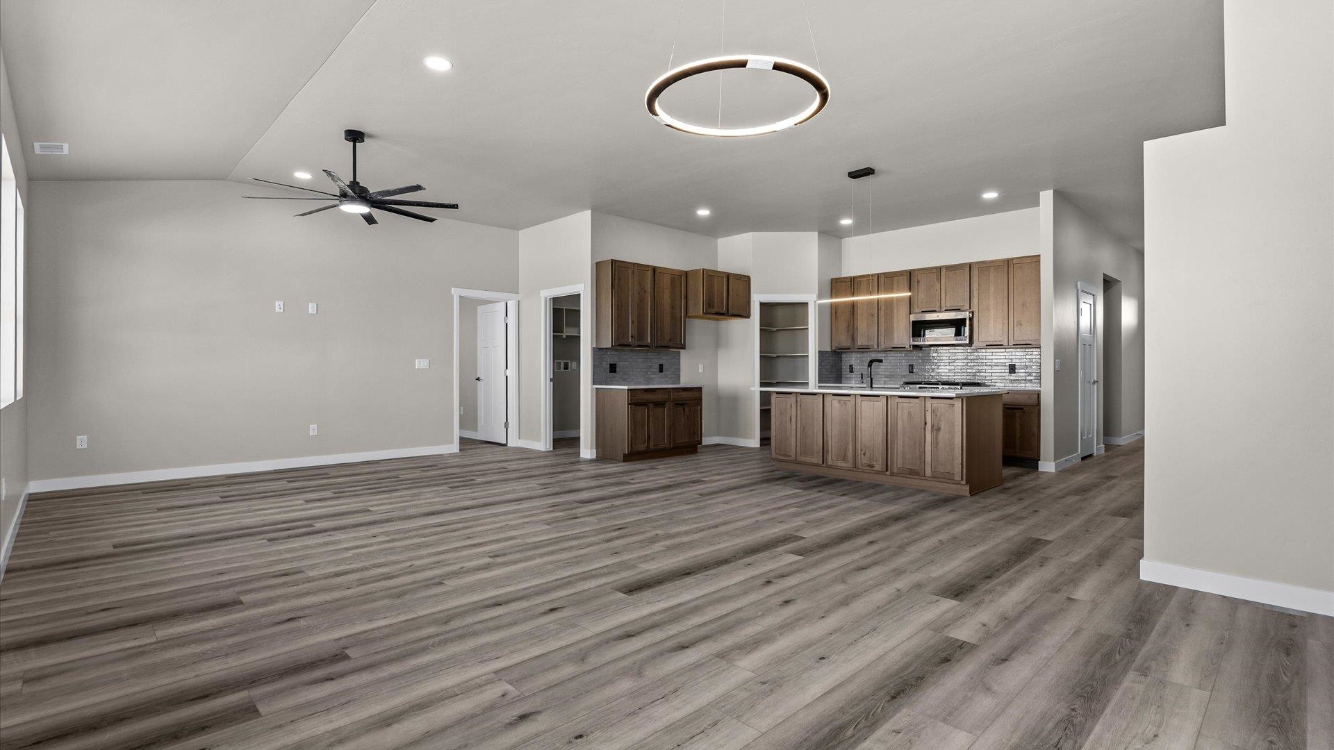 3066 Thunderhead Way Grand Junction, CO 81504 - Photo 14 of 30 a view of kitchen with kitchen island wooden floor center island and stainless steel appliances