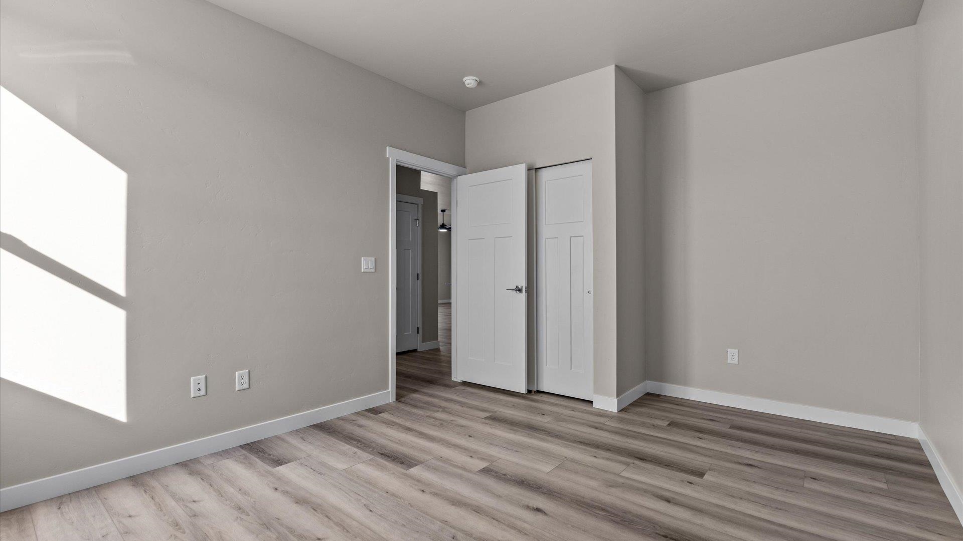 3066 Thunderhead Way Grand Junction, CO 81504 - Photo 24 of 30 a view of an empty room with wooden floor and a window