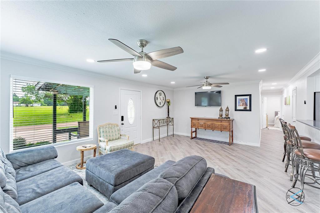 113 Goodknight Ranch Road Trinidad, TX 75163 - Photo 1 of 1 Living room featuring ceiling fan, ornamental molding, and light hardwood / wood-style flooring