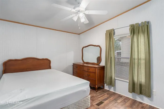 a bedroom with a bed and a dresser