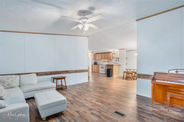 a living room with furniture and wooden floor