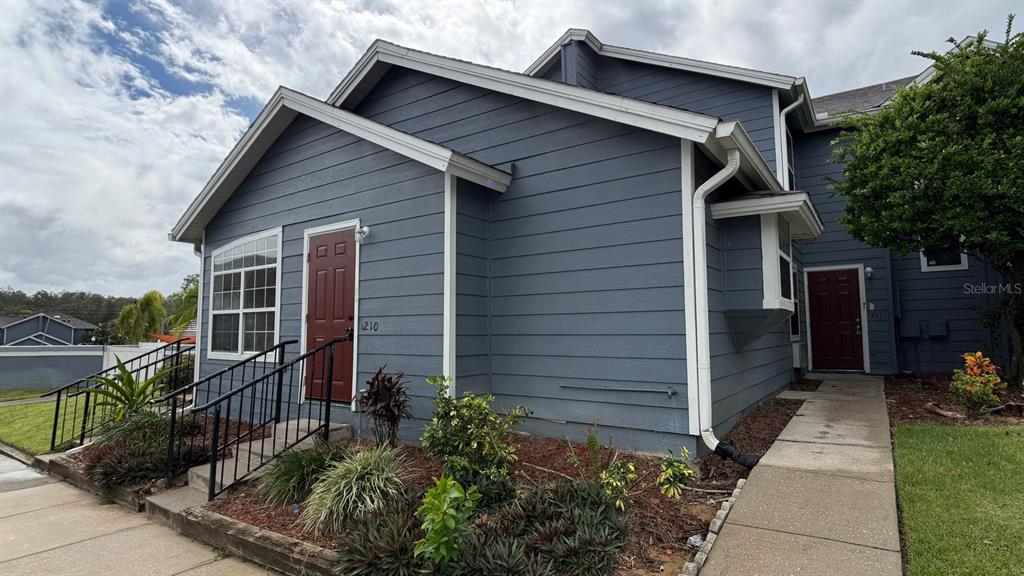 211 Caribbean Drive, Unit LOCKOUT Davenport, FL 33897 - Photo 1 of 14 a front view of a house with a yard