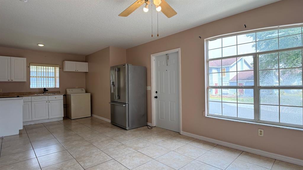 211 Caribbean Drive, Unit LOCKOUT Davenport, FL 33897 - Photo 3 of 14 a kitchen with a refrigerator and a sink
