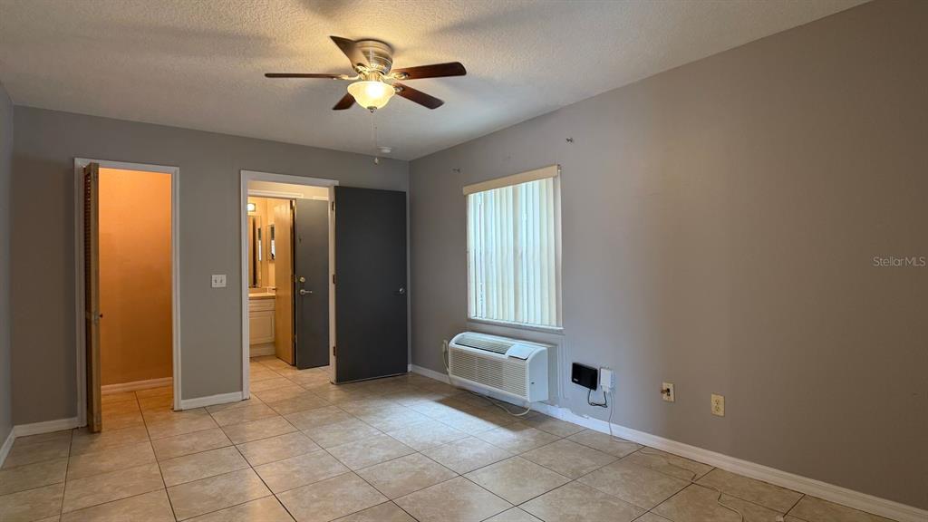 211 Caribbean Drive, Unit LOCKOUT Davenport, FL 33897 - Photo 6 of 14 wooden floor in an empty room with a window
