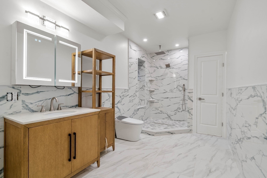 51 Pilgrim Road Needham, MA 02492 - Photo 34 of 42 a bathroom with a granite countertop sink mirror vanity and toilet