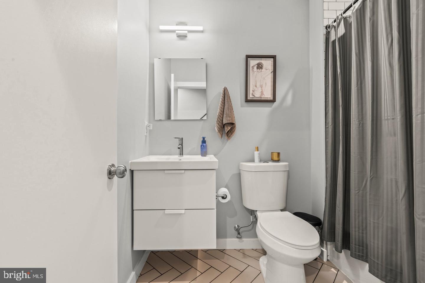 1751 South Taylor Street Philadelphia, PA 19145 - Photo 15 of 28 a bathroom with a toilet sink and mirror