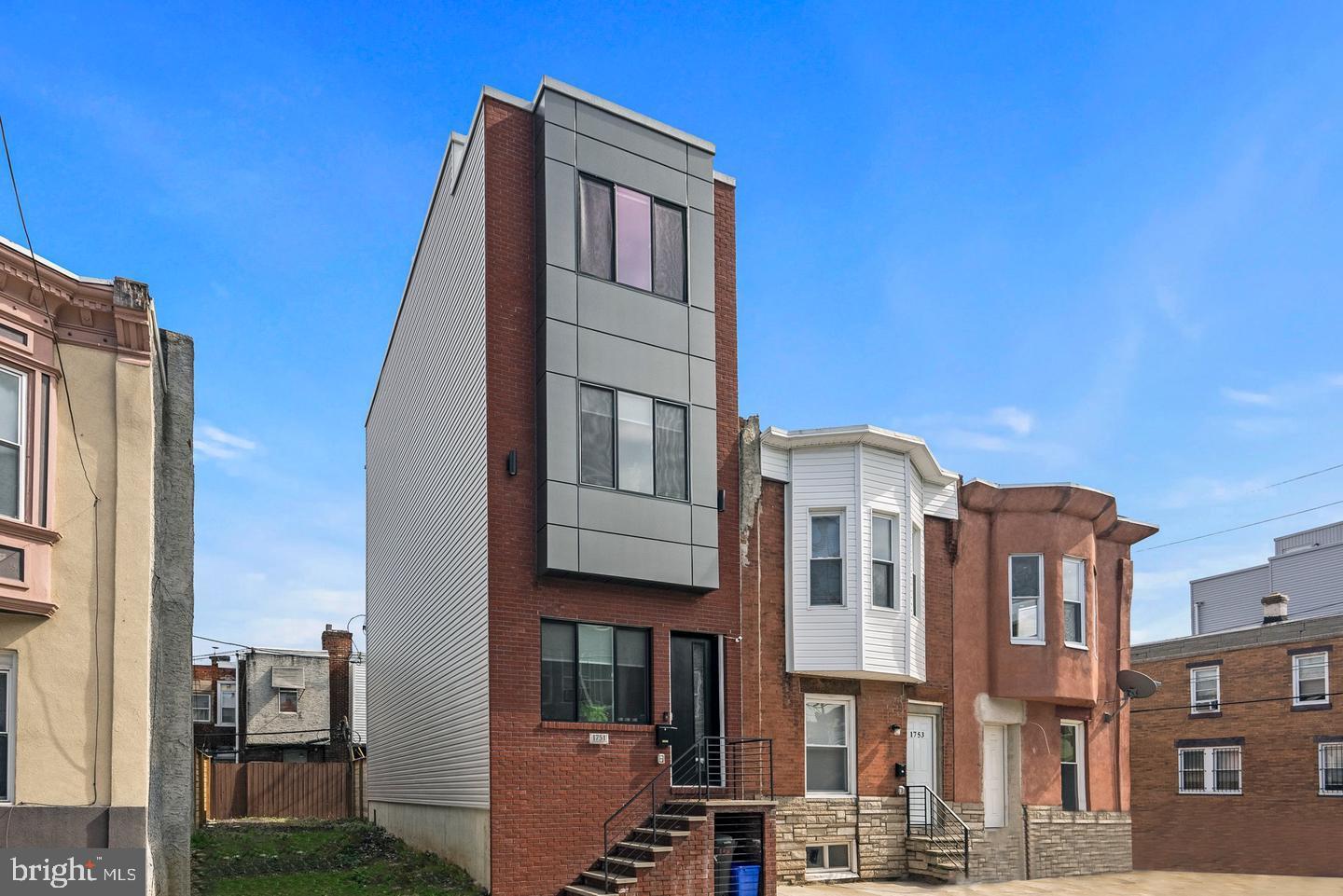 1751 South Taylor Street Philadelphia, PA 19145 - Photo 27 of 28 a front view of a residential apartment building with a yard