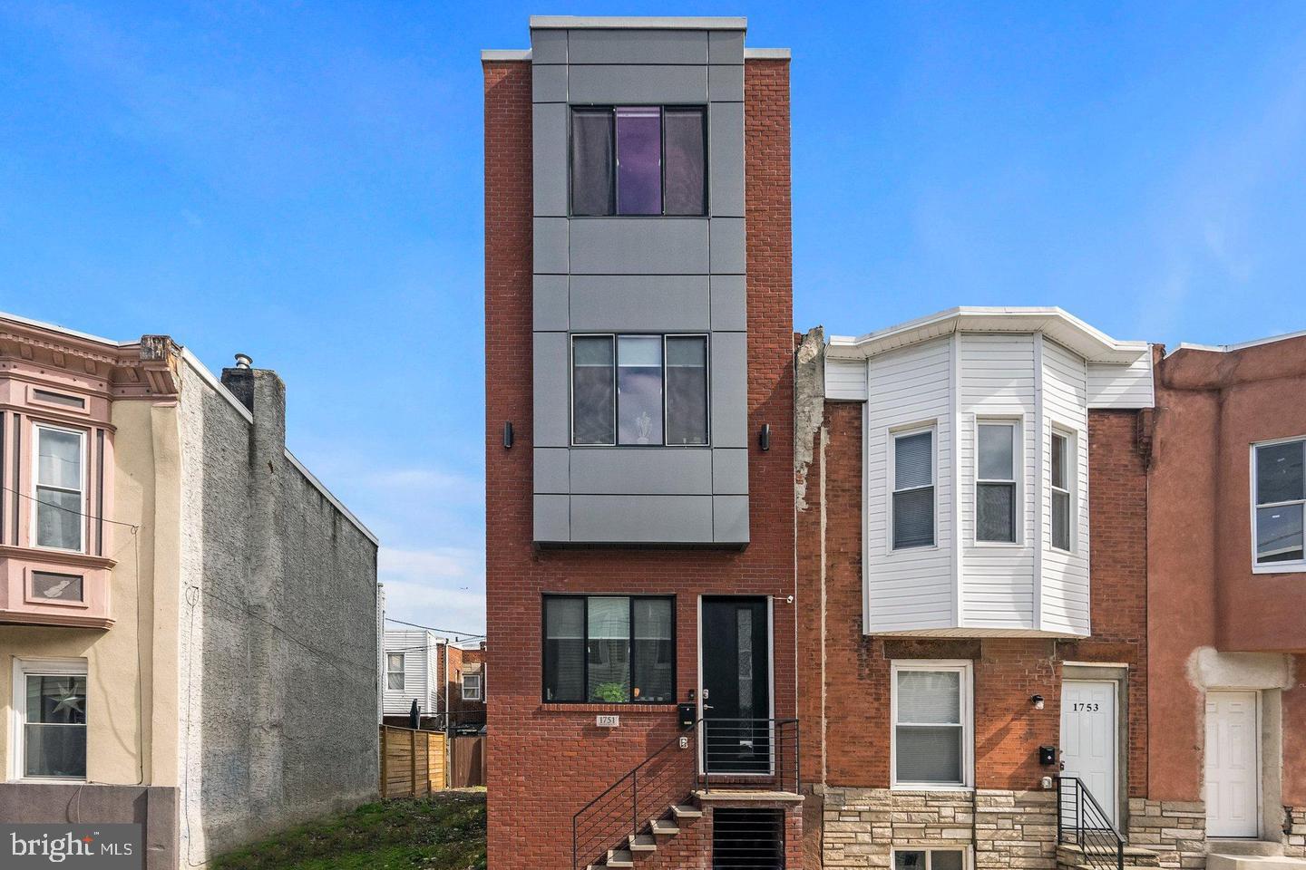 1751 South Taylor Street Philadelphia, PA 19145 - Photo 28 of 28 a front view of a residential apartment building with a yard