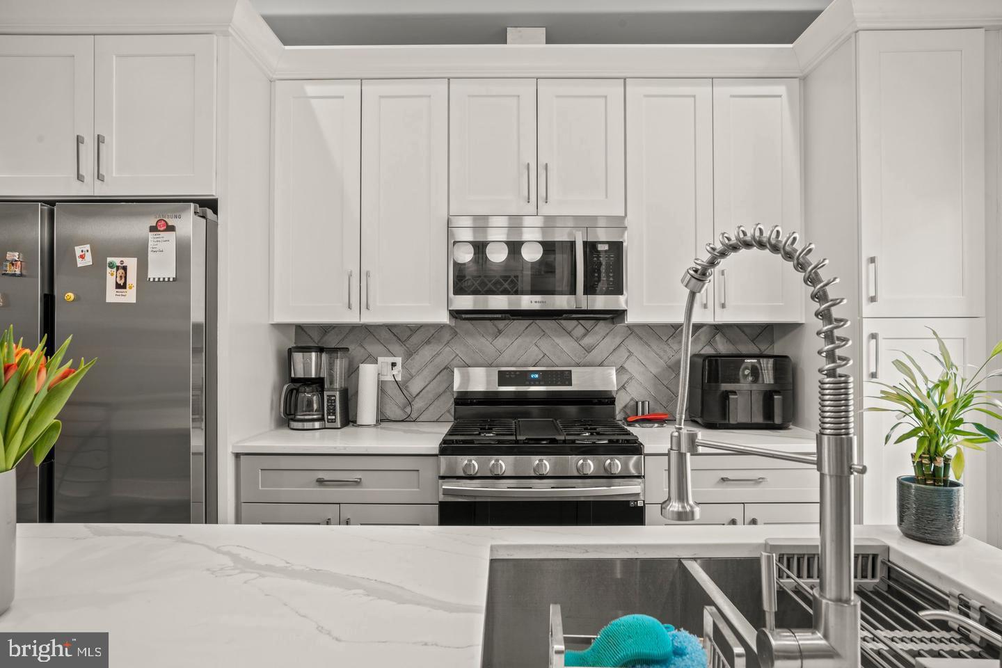 1751 South Taylor Street Philadelphia, PA 19145 - Photo 7 of 28 a kitchen with stainless steel appliances granite countertop a stove a microwave and cabinets