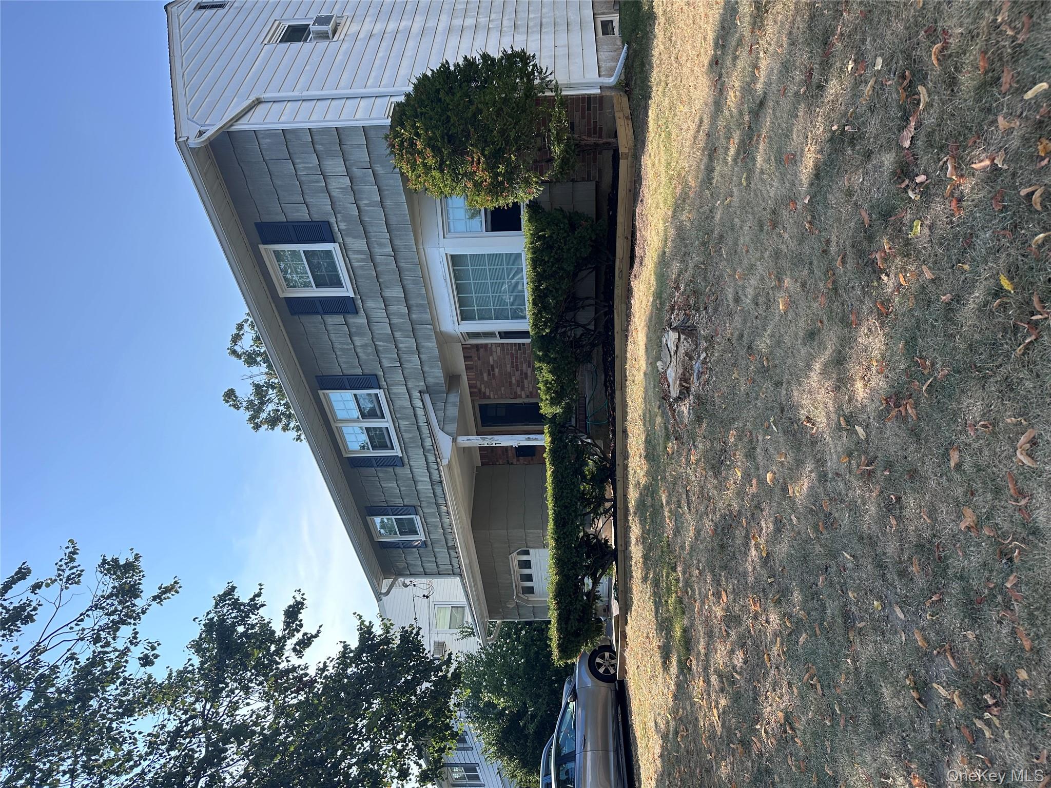 107 Fairview Avenue Oceanside, NY 11572 - Photo 1 of 14 a front view of a house with a yard and garage