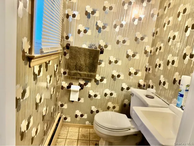 a white toilet sitting next to a shower curtain