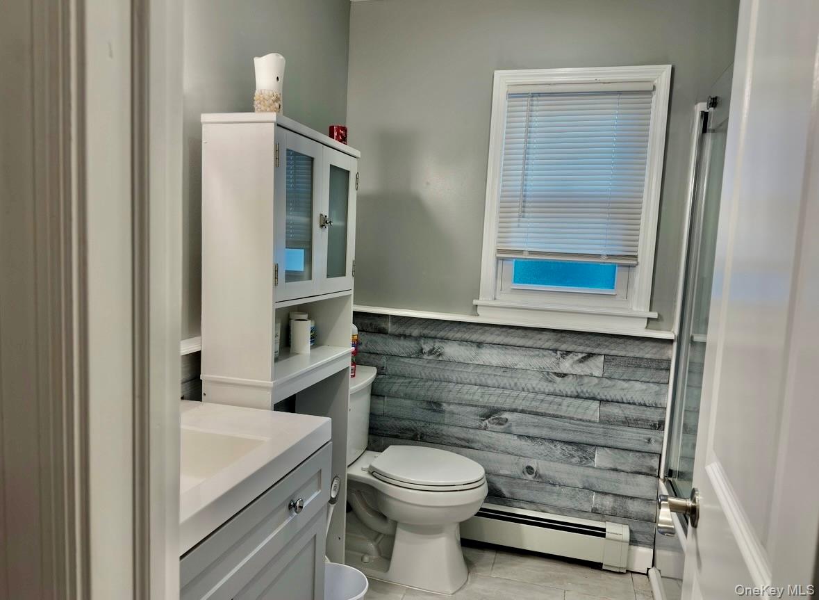107 Fairview Avenue Oceanside, NY 11572 - Photo 9 of 14 a bathroom with a toilet a sink and mirror