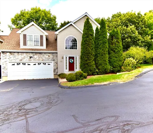 a view of a house with a yard and potted plants