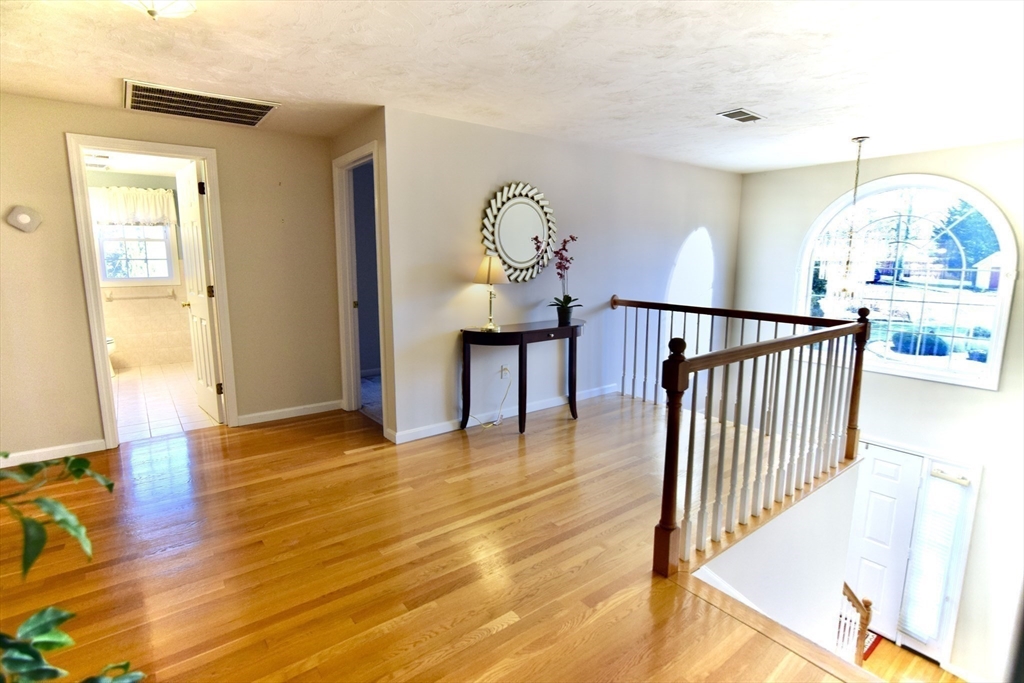 172 Edgehill Road, Unit 172 Norwood, MA 02062 - Photo 11 of 27 a view of a hallway with wooden floor and door