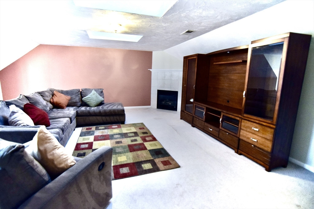 172 Edgehill Road, Unit 172 Norwood, MA 02062 - Photo 14 of 27 a living room with furniture and a flat screen tv