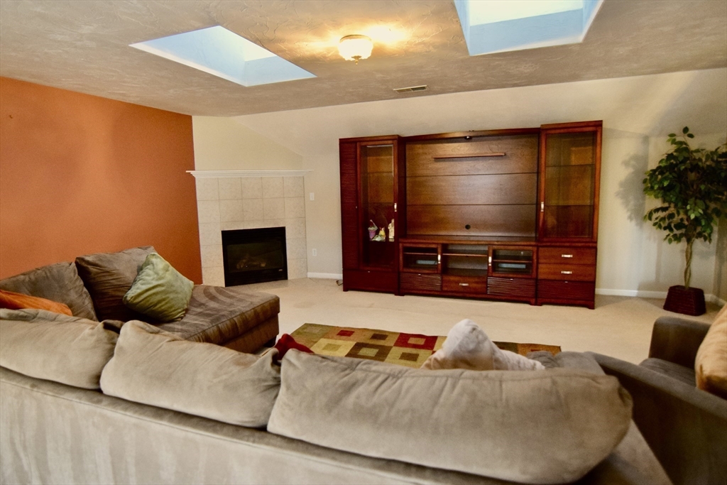 172 Edgehill Road, Unit 172 Norwood, MA 02062 - Photo 15 of 27 a living room with furniture and a flat screen tv