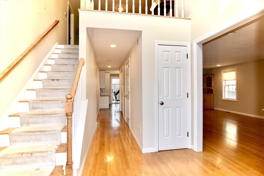 172 Edgehill Road, Unit 172 Norwood, MA 02062 - Photo 20 of 27 a view of a hallway with wooden floor and staircase
