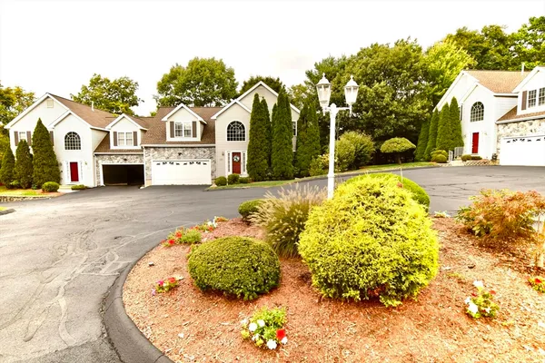 a view of a white house with a yard