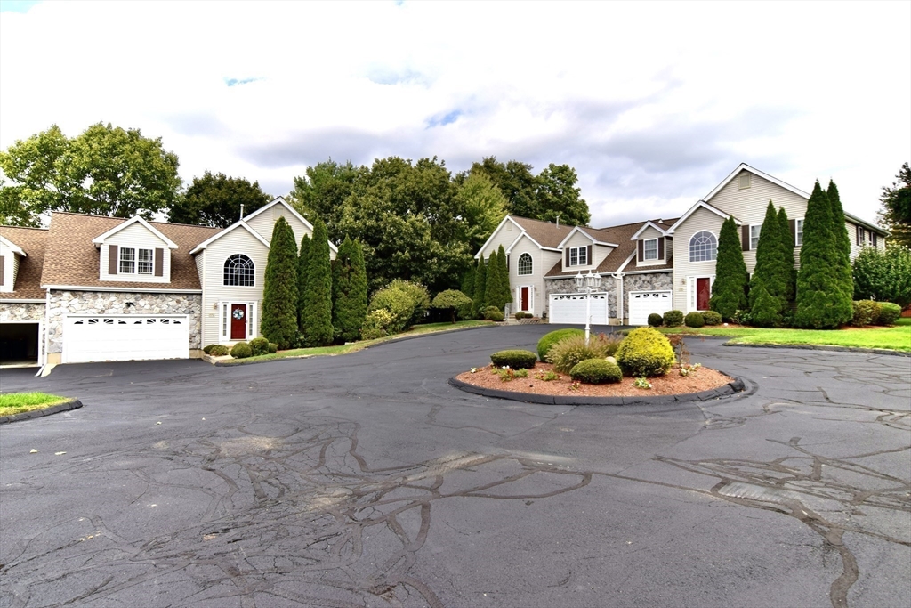 172 Edgehill Road, Unit 172 Norwood, MA 02062 - Photo 24 of 27 a view of a white house with a big yard and large tree