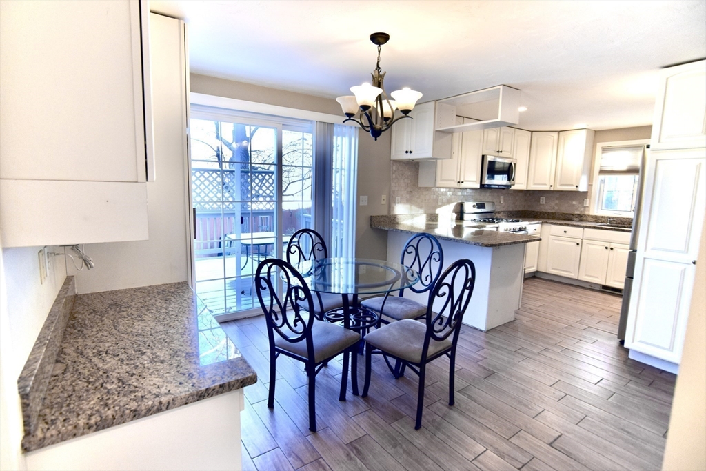 172 Edgehill Road, Unit 172 Norwood, MA 02062 - Photo 4 of 27 a view of a dining room with furniture and wooden floor
