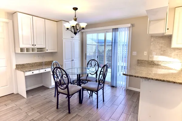 a view of a a dining room with furniture window and wooden floor