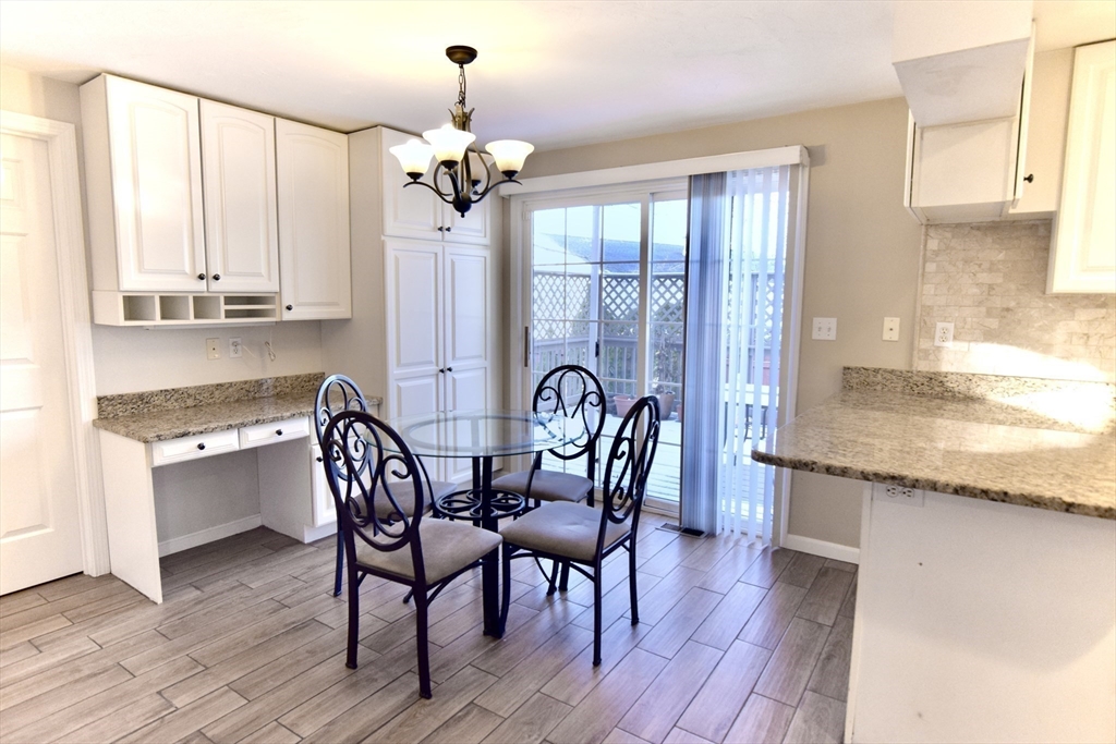172 Edgehill Road, Unit 172 Norwood, MA 02062 - Photo 5 of 27 a view of a a dining room with furniture window and wooden floor